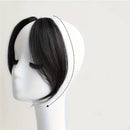 Pack of 2 natural black hair extensions on a mannequin head with close-up of one extension, Obroi