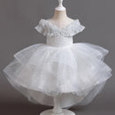 White children's dress on a mannequin against a gray background, Obroi