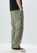 Person wearing green cargo pants on a white background, Obroi