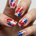 Nails with red, blue, and white floral design on a neutral background, Obroi