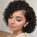 Woman with styled curly hair wearing a light-colored top indoors, Obroi