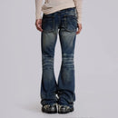 Person wearing blue flared jeans on a plain background, Obroi