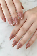 Close-up of hands with nude-colored nail polish on a light background, Obroi