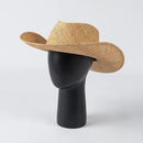 Woven straw cowboy hat on a black mannequin head against a white background, Obroi