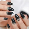Black stiletto nails with gold glitter on a neutral background, Obroi
