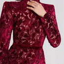 Red lace dress with a hand adjusting the neckline on a light gray background, Obroi