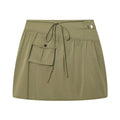 An olive green mini skirt with a drawstring waist, a side pocket with a snap button, and a small silver metal accent on the hip, shown against a plain white background, Obroi