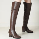 Brown knee-high boots on a light background, Obroi