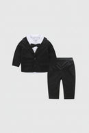 Black velvet suit with bow tie and pants on a white background, Obroi