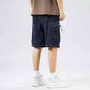 Person wearing navy cargo shorts on a white background, Obroi