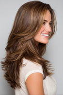 Brown hairpiece shown on a woman's head with three inset views: side profile of the model, top view of the hairpiece, and underside cap view, on a light gray background, Obroi
