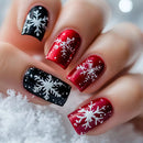 Nails with red, black, and white snowflake designs on a snowy background, Obroi