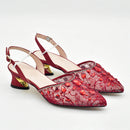 Red lace shoes with gold accents on a white background, Obroi