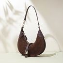 Brown suede handbag with purple accents on a light background, Obroi
