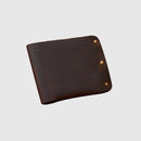 Brown leather wallet with gold rivets on a light gray background, featuring the Obroi brand 