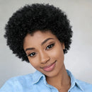 Woman with styled afro wearing a light blue denim shirt against a plain background, Obroi