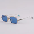 Sunglasses with blue lenses and silver frame on a light gray background, Obroi