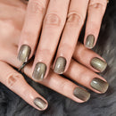 Close-up of hands with metallic gold nail polish on a fur background, Obroi