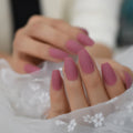 Close-up of hands with pink nail polish on a blurred background ,Obroi