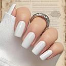 Close-up of a hand with white nail polish on a textured background, Obroi