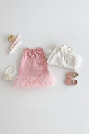 Pink dress with ruffles, white top with bow, and pink shoes on a light background, Obroi