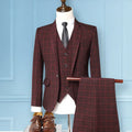 Red plaid suit on a mannequin against a light blue wall, Obroi