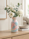 Decorative vase with floral arrangement on a wooden surface in a home setting, Obroi
