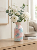 Decorative vase with floral arrangement on a wooden surface in a home setting, Obroi