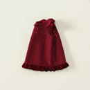 Red children's coat with ruffled details on a beige background, Obroi