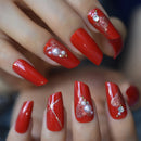 Close-up of red nail polish with pearls and rhinestones on a blurred background, Obroi
