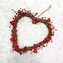 Heart-shaped wreath with red berries and hearts on a textured white background, Obroi