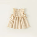 Beige dress with ruffled details on a light beige background, Obroi