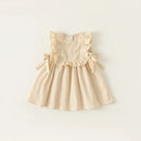 Beige dress with ruffled details on a light beige background, Obroi