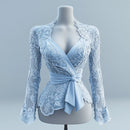 Light blue lace top on a mannequin against a gray background obroi