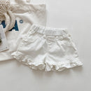 White denim shorts with ruffled edges on a light gray background, Obroi