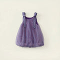 A toddler girl's sleeveless tutu dress in sparkling lavender purple tulle with matching ribbon shoulder straps, shown flat against a light cream background with decorative text overlays, Obroi