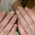Nails with gold leaf design on a neutral background, Obroi