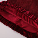 Close-up of a red velvet fabric with ruffled edge on a light background, Obroi