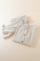 Folded beige ribbed pajama set on a light beige background, Obroi