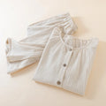 Folded beige ribbed pajama set on a light beige background, Obroi