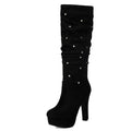 Black knee-high boot with platform sole and decorative buttons on a white background, Obroi