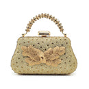 Gold evening bag with floral design and beaded handle on a white background, Obroi