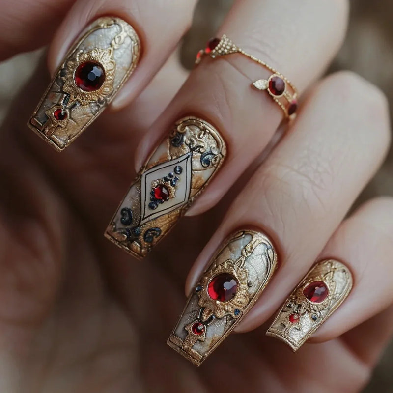 Decorative nail art with gold and red gemstones on a blurred background, Obroi