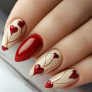 Nails with red and beige design featuring hearts on a neutral background, Obroi