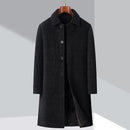 Black coat on a hanger with Obroi branding in the corner.