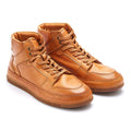 Pair of tan leather high-top sneakers on a white , Obroi