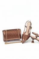 Bronze clutch bag and high-heeled shoes on a white background, Obroi
