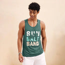 Person wearing a green tank top with 'Sun Salt Sand' text on a beige background