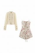 A two-piece women's outfit set featuring a cream lace long-sleeve jacket with dark buttons and a matching sleeveless floral romper with pink and green flowers, displayed on a solid white background, Obroi