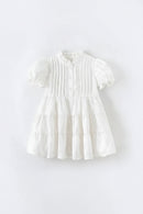 White dress with ruffled details on a light gray background, Obroi